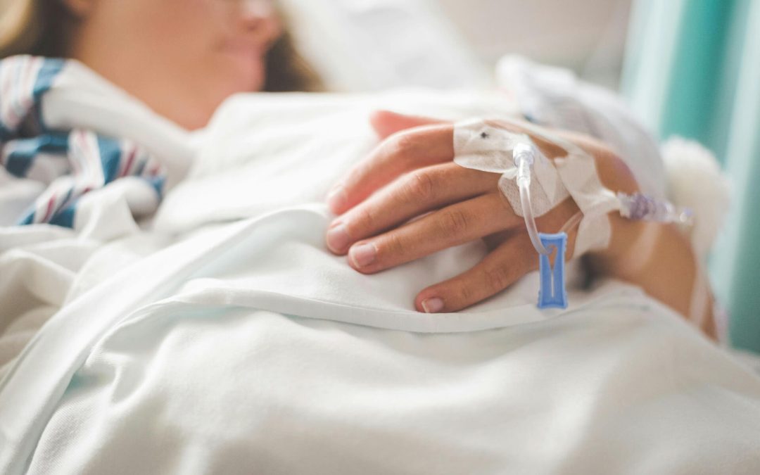 patient in hospital bed on a drip after a slip and fall accident